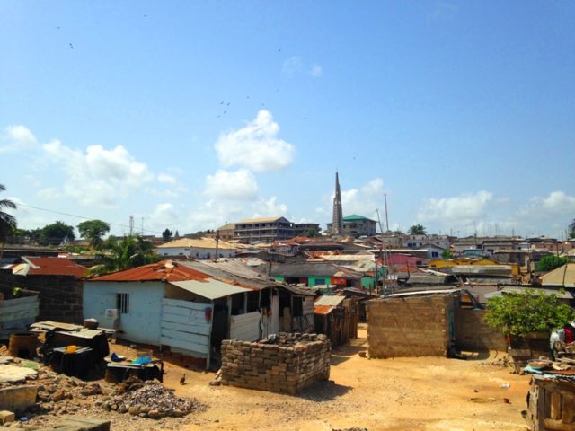A view overlooking much of the town of Winneba. The buildings are homes and businesses, with fish smoking ovens. Running offers prime opportunity to explore and learn to navigate through town.