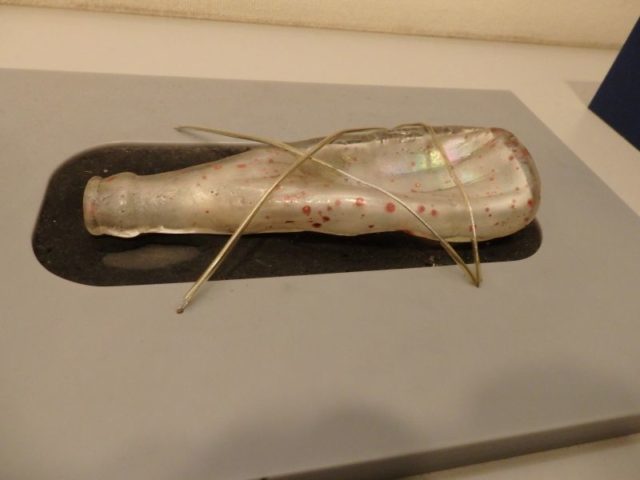 a melted glass bottle in the Hiroshima Peace Memorial Museum